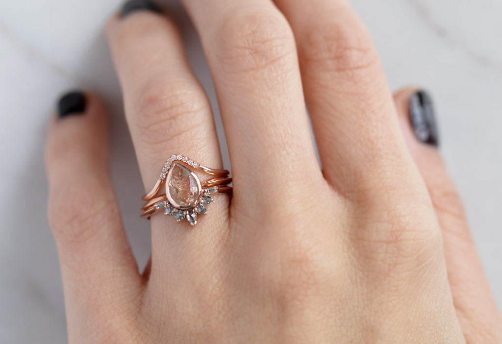 The Posy Ring with a Pear-Cut Sunstone with Stacking Bands on Model