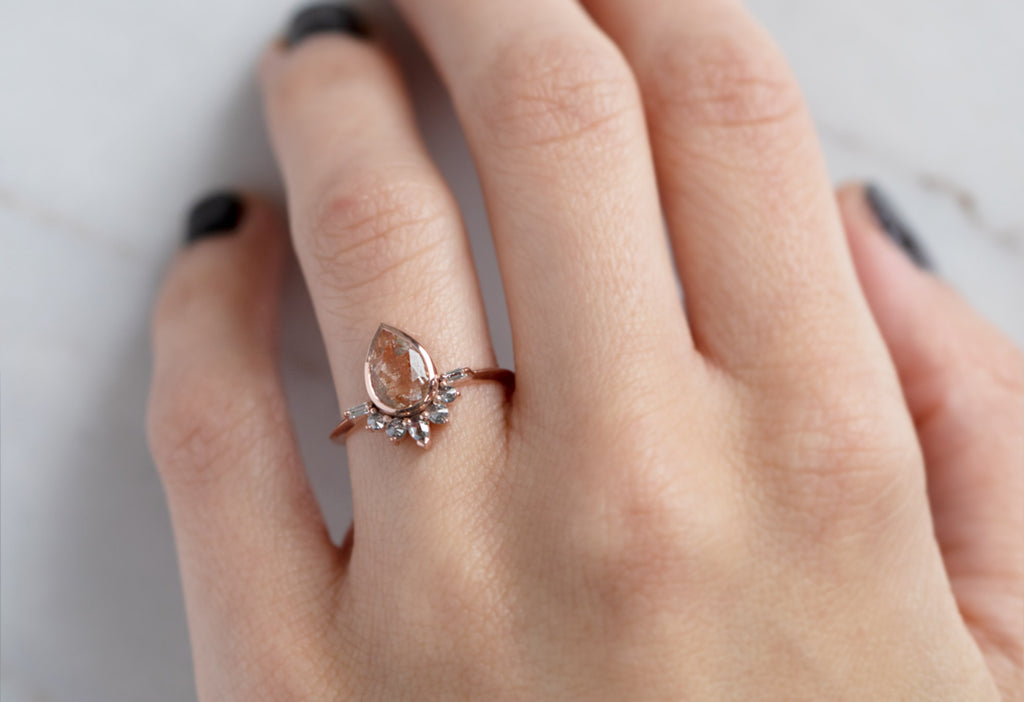 The Posy Ring with a Pear-Cut Sunstone on Model