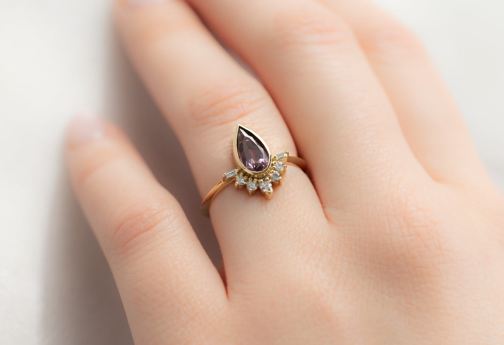 The Posy Ring with a Pear-Cut Violet Sapphire on Model