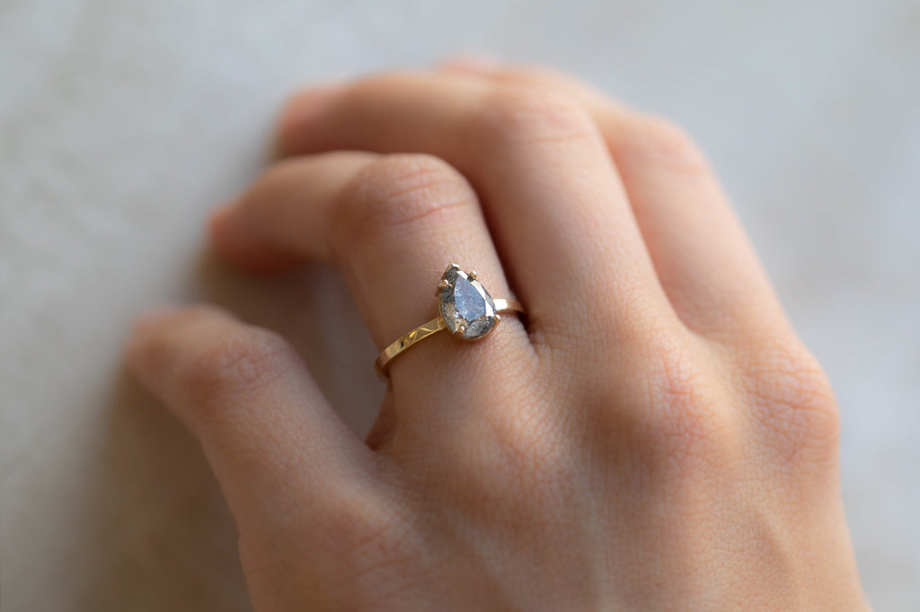 The Sage Ring With A Pear-Cut Salt and Pepper Diamond On Model