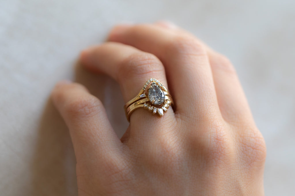 The Sage Ring With A Pear-Cut Salt and Pepper Diamond With Stacking Bands on Model