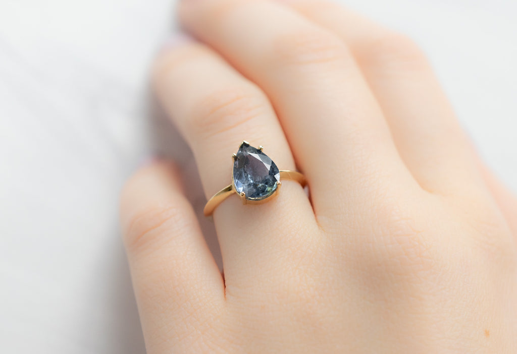 The Sage Ring with a Pear-Cut Sapphire on Model
