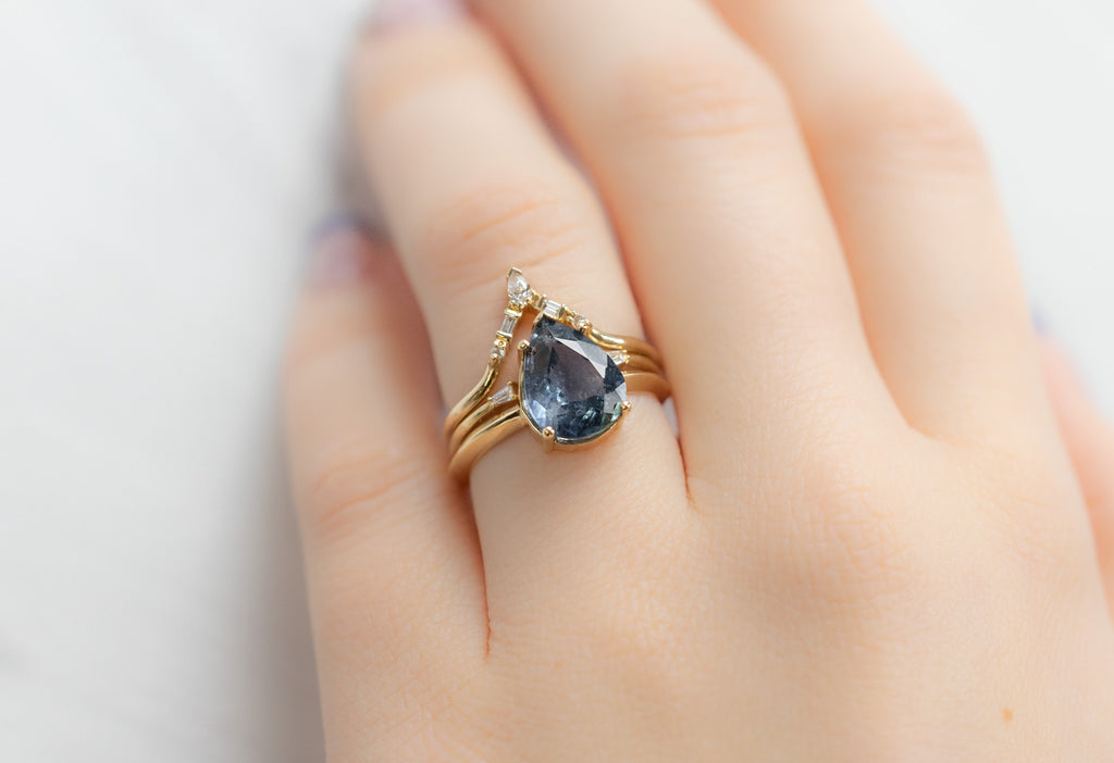 The Sage Ring with a Pear-Cut Sapphire with Stacking Bands on Model