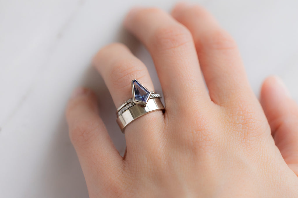 The Willow Ring with a Geometric Tanzanite with Stacking Bands on Model