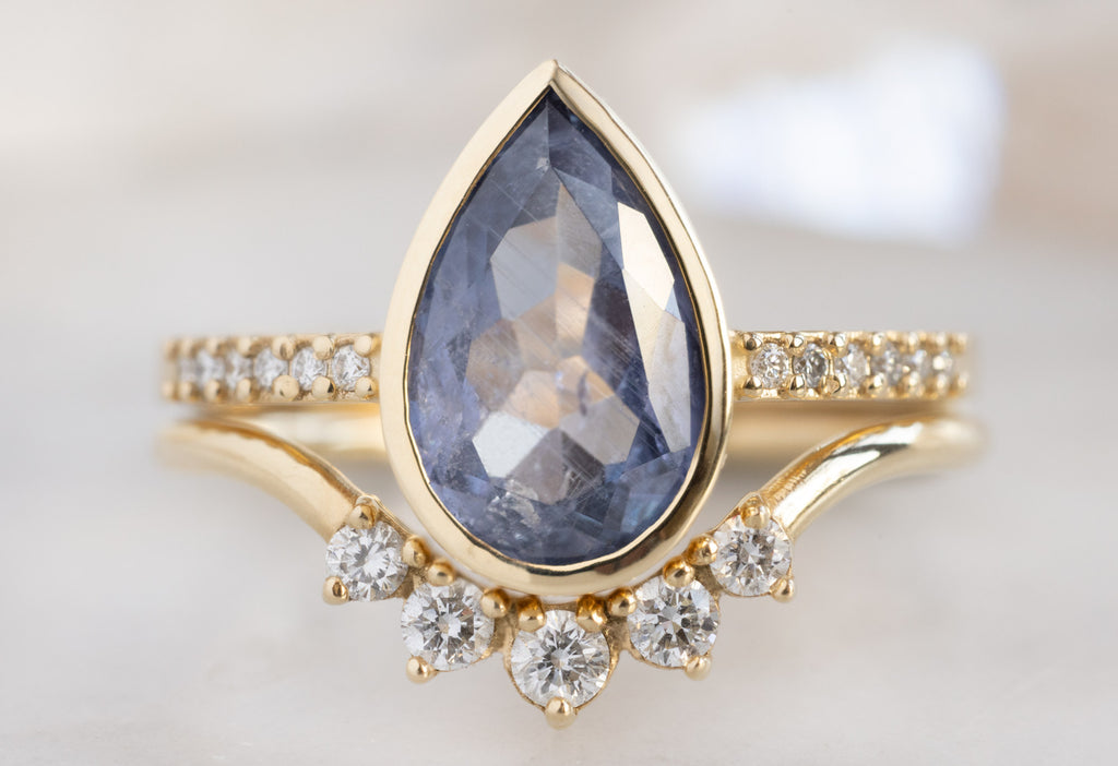 The Willow Ring with a Pear-Cut Blue Violet Sapphire with Round Diamond Sunburst Stacking Band