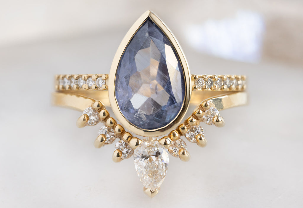 The Willow Ring with a Pear-Cut Blue Violet Sapphire with White Diamond Sunburst Stacking Band