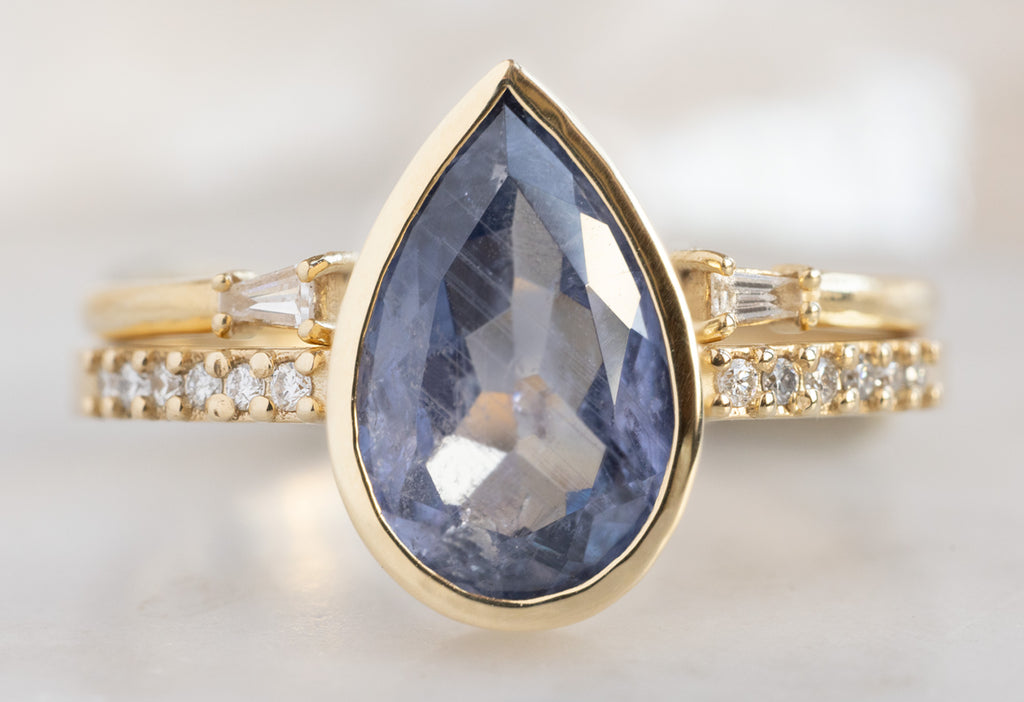 The Willow Ring with a Pear-Cut Blue Violet Sapphire with Open Cuff Diamond Baguette Stacking Band