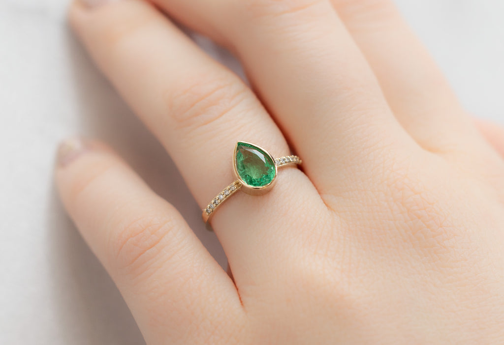 The Willow Ring with a Pear-Cut Emerald on Model