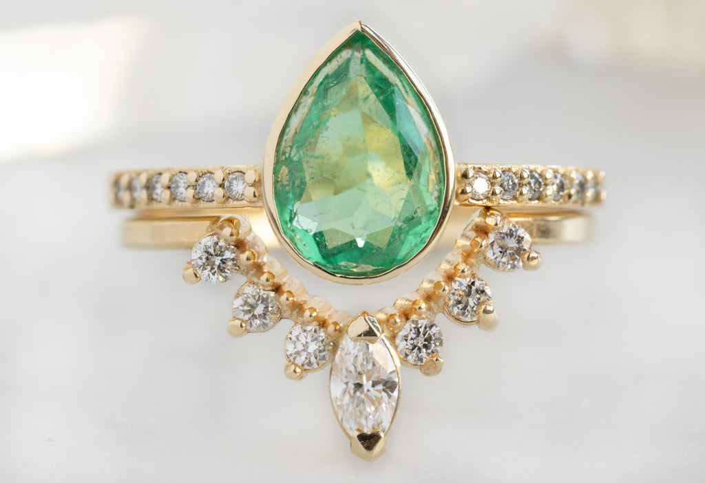 The Willow Ring with a Pear-Cut Emerald with White Diamond Sunburst Stacking Band