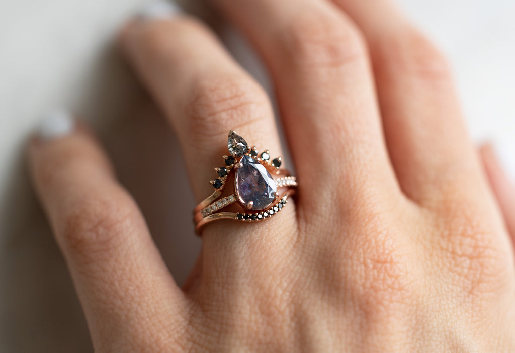 The Willow Ring with a Pear-Cut Grey-Violet Sapphire with Stacking Bands on Model