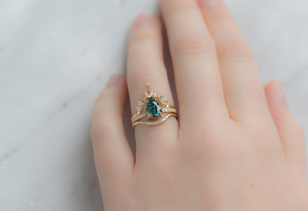 The Willow Ring with a Pear-Cut Montana Sapphire with Stacking Bands on Model