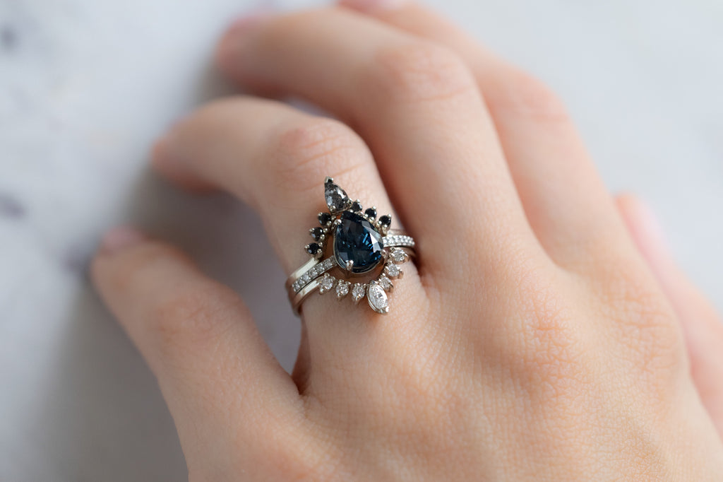 The Willow Ring with a Pear-Cut Montana Sapphire with Stacking Bands on Model
