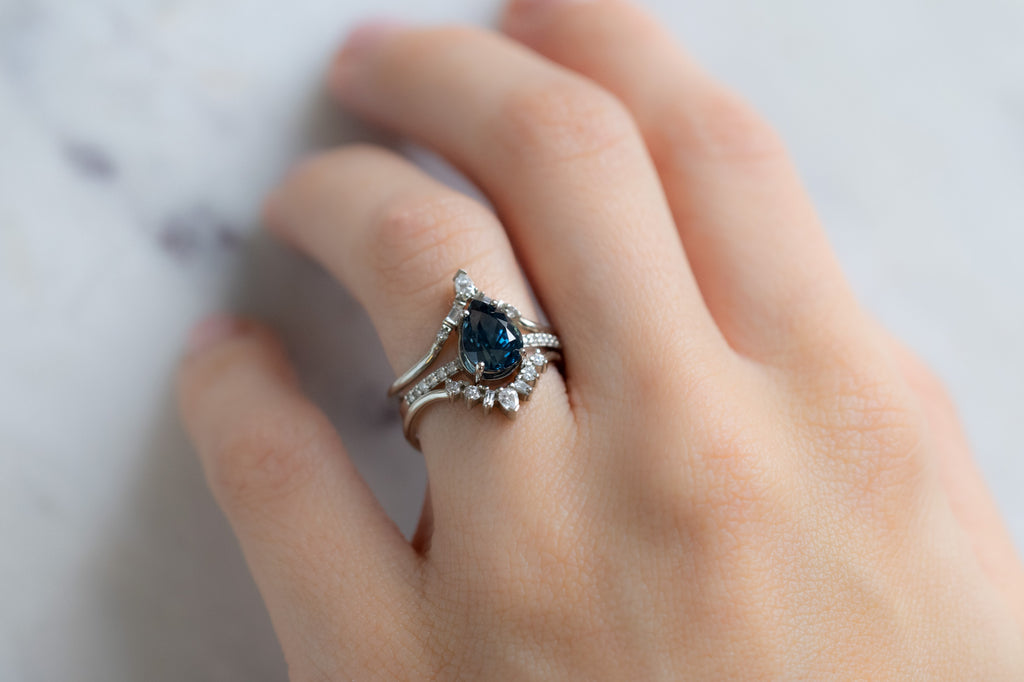 The Willow Ring with a Pear-Cut Montana Sapphire with Stacking Bands on Model