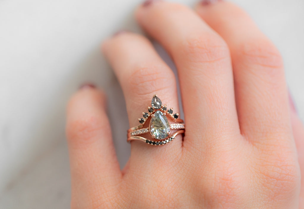 The Willow Ring with a Pear Cut Sapphire with Stacking Bands on Model