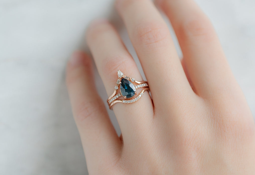 The Willow Ring with a Pear-Cut Sapphire with White Diamond Stacking Bands on Model