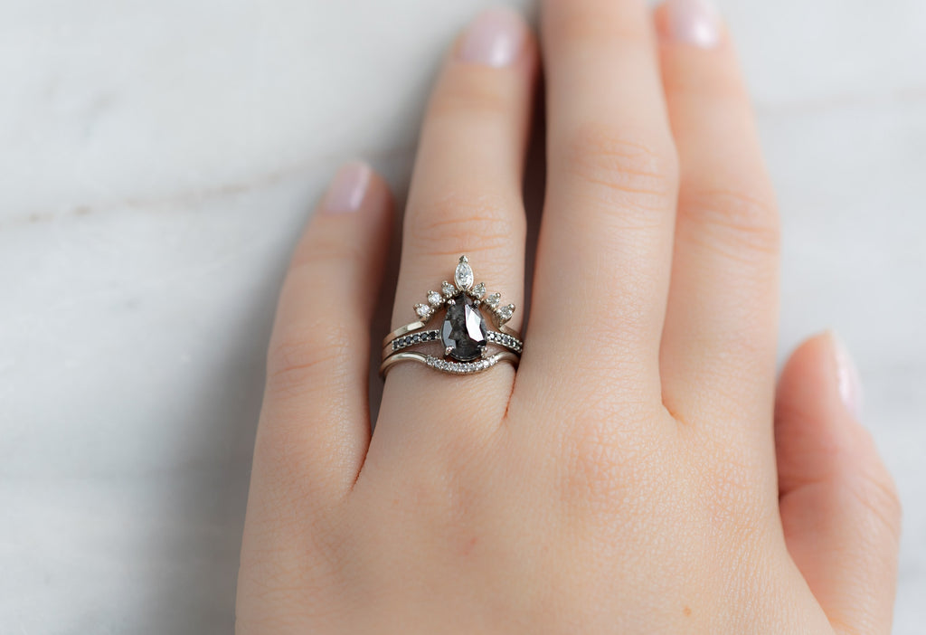 The Willow Ring with a Rose-Cut Black Diamond with Stacking Bands on Model