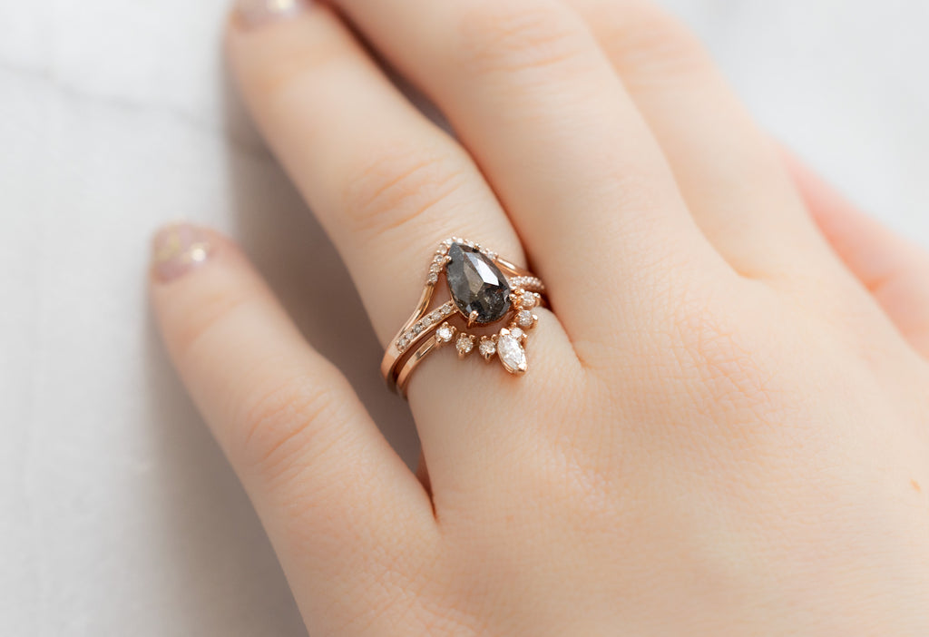 The Willow Ring with a Rose-Cut Black Diamond with White Diamond Stacking Bands on Model