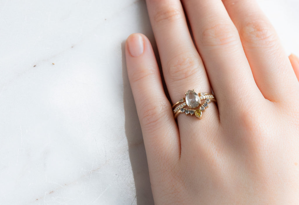 The Willow Ring with a Rose-Cut Green Diamond with Stacking Bands on Model