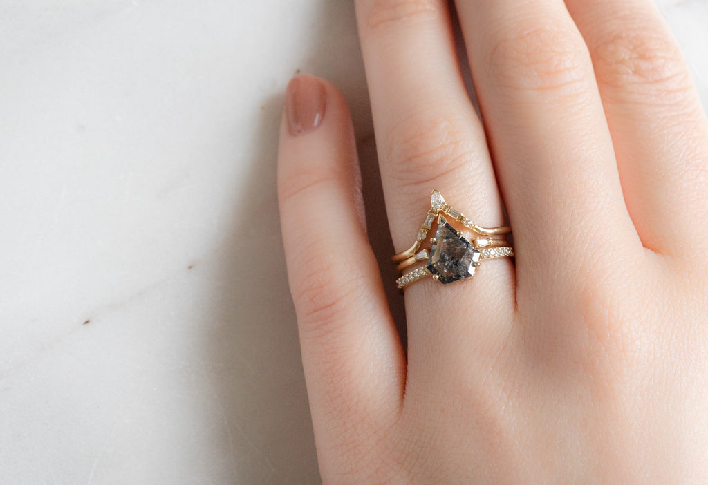 The Willow Ring with a Shield-Cut Black Diamond with Stacking Bands on Model with White Diamond Stacking Bands