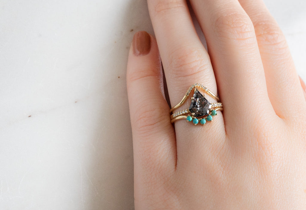 The Willow Ring with a Shield-Cut Black Diamond with Stacking Bands on Model