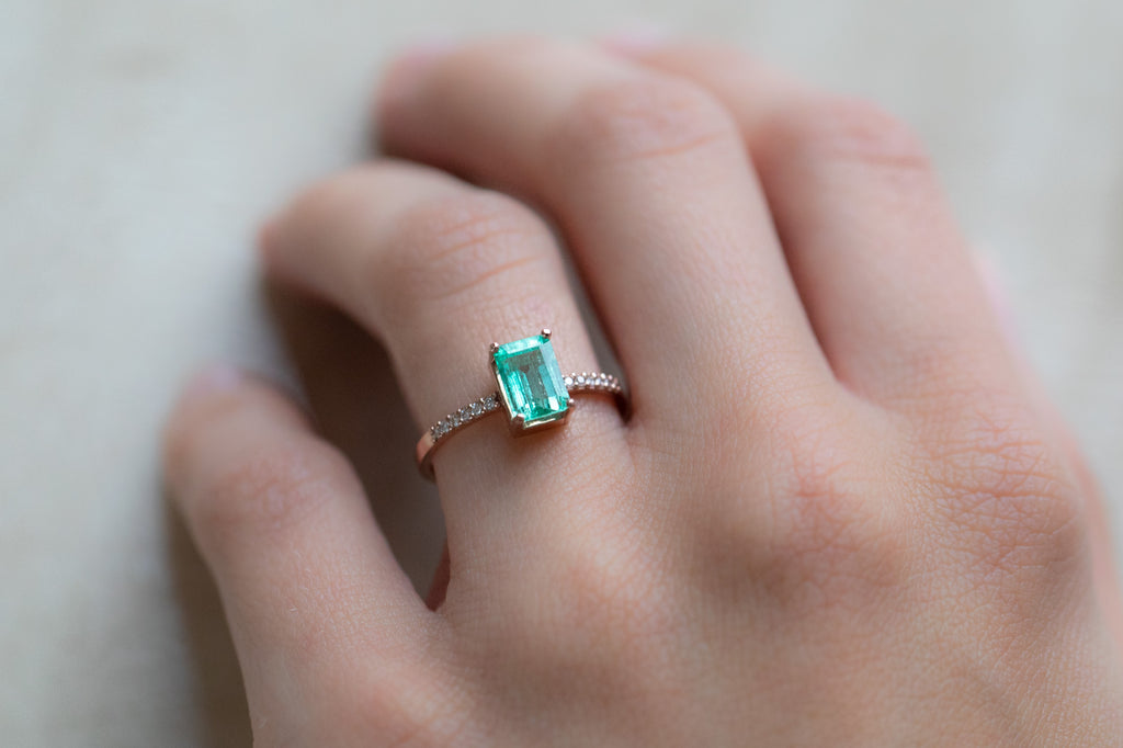 The Willow Ring with an Emerald-Cut Emerald on Model