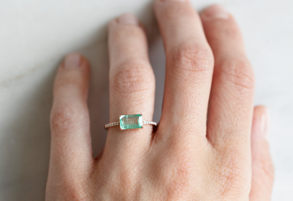 The Willow Ring with an Emerald Cut Emerald on Model