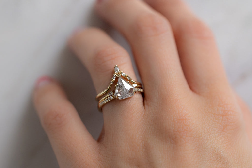 The Willow Ring with an Opalescent Shield-Cut Diamond with Stacking Bands on Model