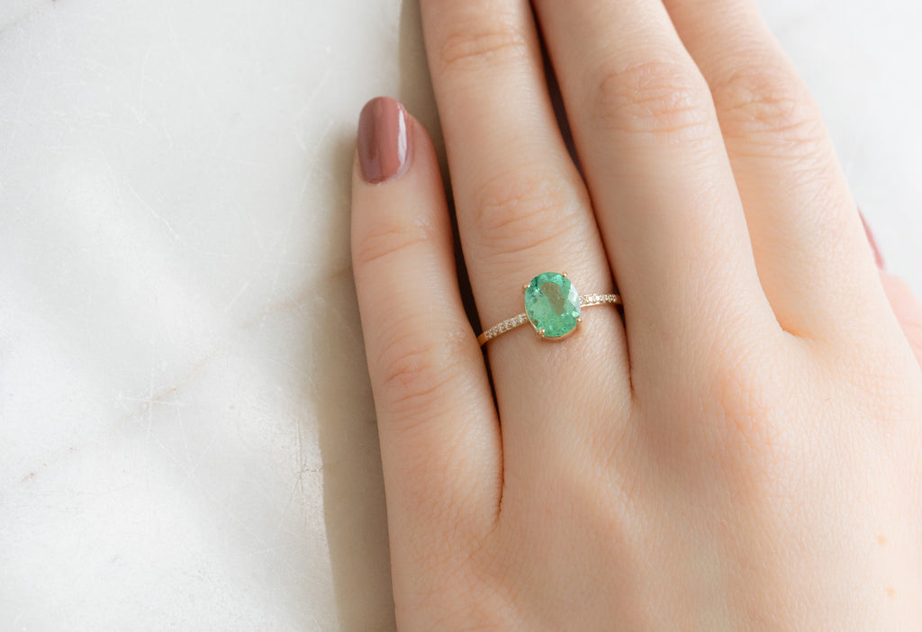 The Willow Ring with an Oval-Cut Emerald on Model