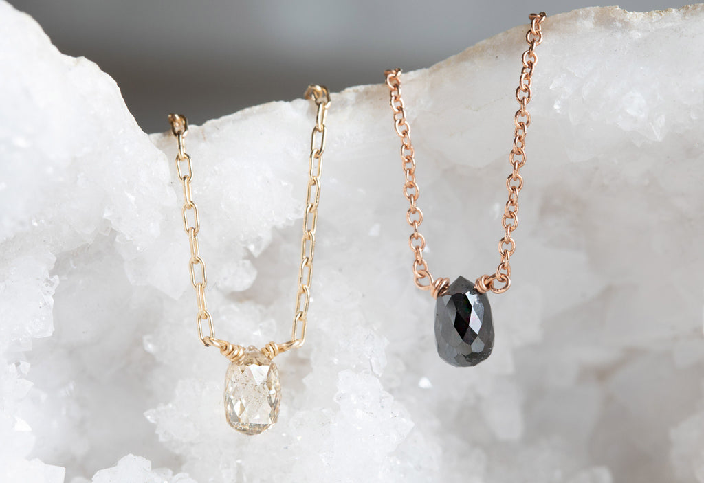 Champagne and Black Briolette Diamond Necklaces draped over white druzy crystal