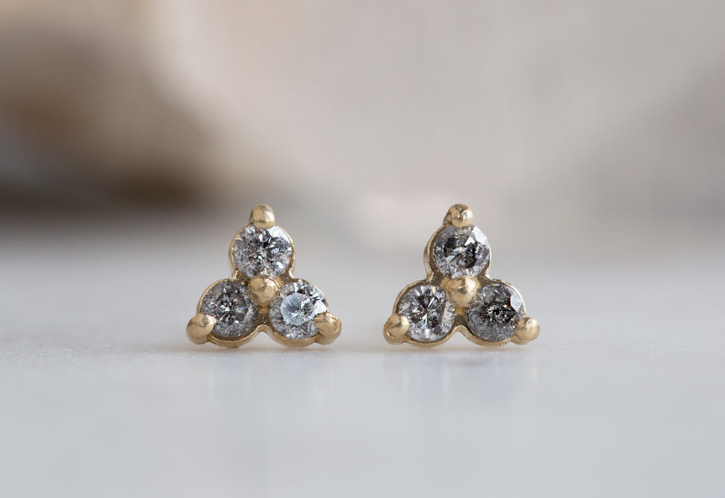 Diamond Cluster Stud Earrings on white marble tile