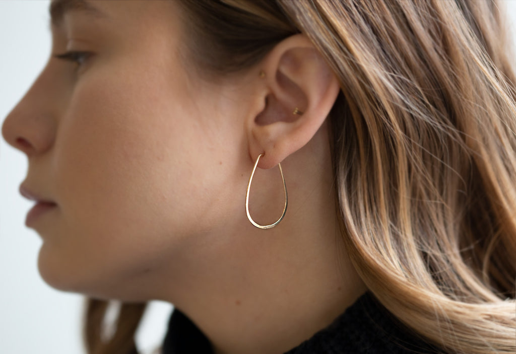 Small Horseshoe Gold Hoop Earrings on model