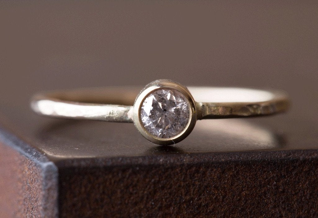 Hammered Teensy Custom Diamond Stacking Ring on cement table