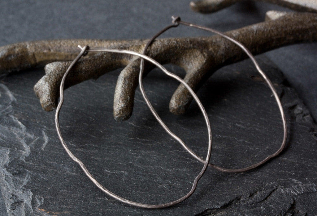 Organic Hoop Earrings laying on metal earring tree