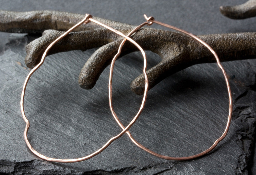 Organic Hoop Earrings laying on metal earring tree