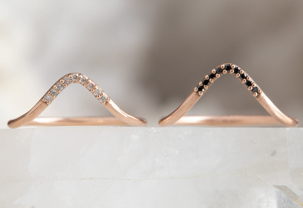 two rose gold pavé peak stacking bands with white and black diamonds